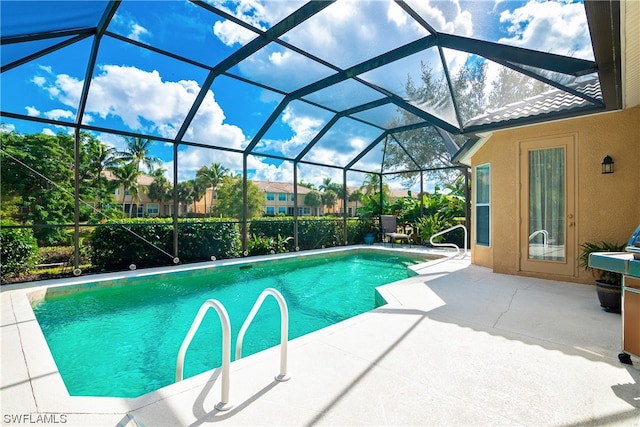 view of pool with a lanai and a patio area