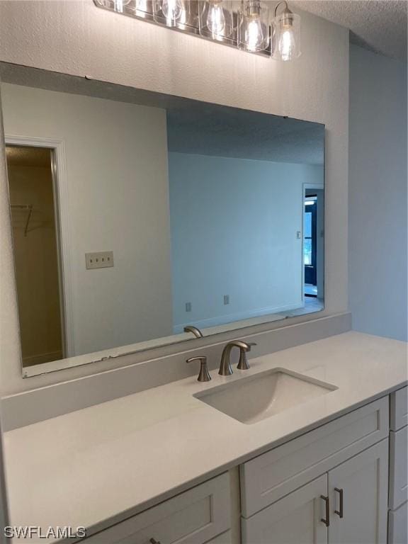 bathroom featuring a textured ceiling and vanity