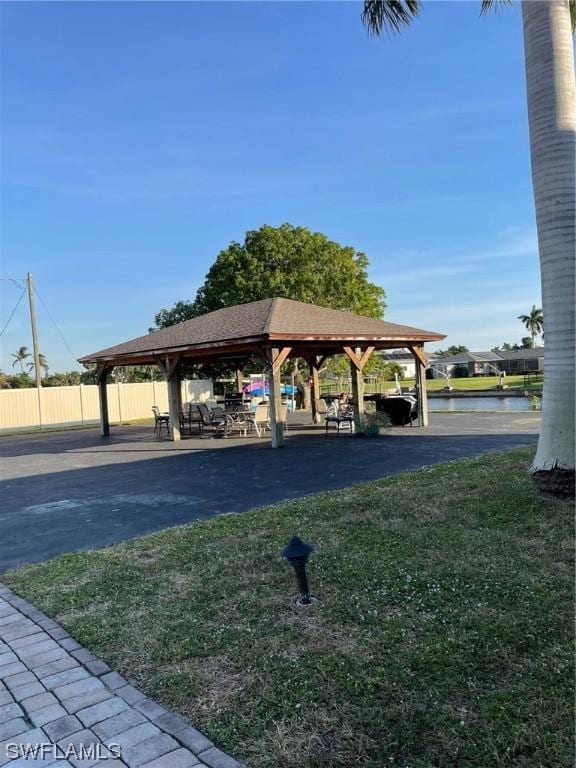 view of community featuring a yard, a gazebo, and fence