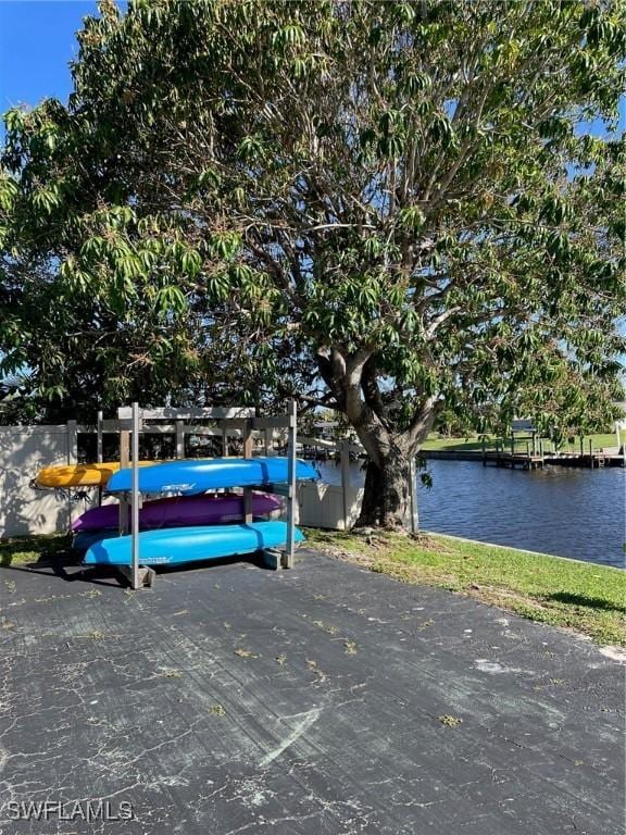 view of vehicle parking with a water view