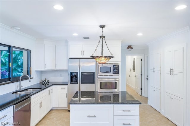 kitchen featuring sink, decorative light fixtures, white cabinetry, and appliances with stainless steel finishes