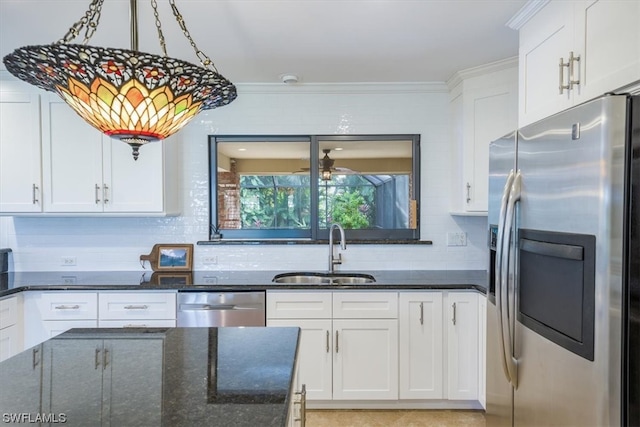 kitchen with white cabinets, appliances with stainless steel finishes, sink, and tasteful backsplash