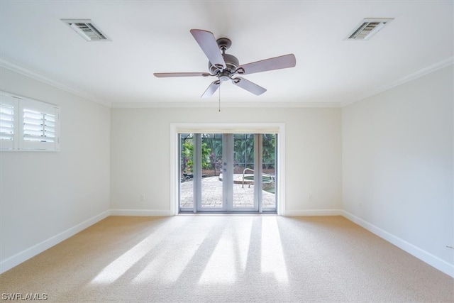 carpeted spare room featuring ornamental molding and ceiling fan