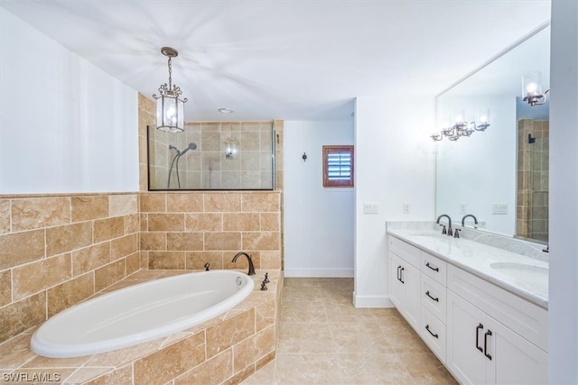 bathroom featuring double vanity, tiled tub, and tile flooring