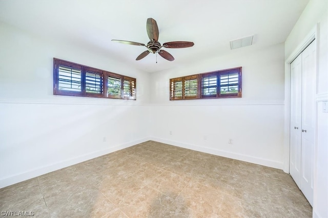 unfurnished bedroom featuring tile flooring, a closet, and ceiling fan