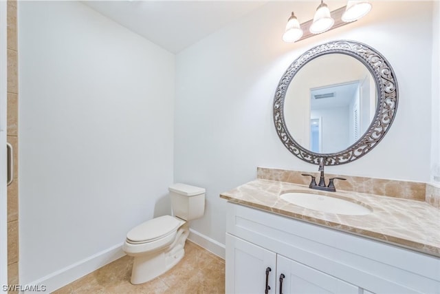 bathroom with tile flooring, vanity, and toilet