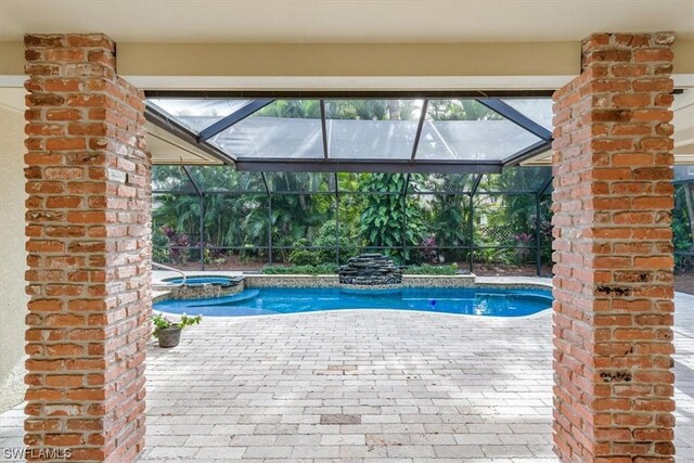 view of swimming pool with a patio and glass enclosure