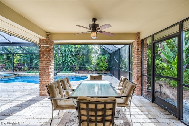 view of patio / terrace featuring glass enclosure and ceiling fan