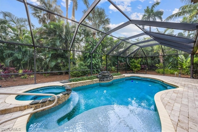 view of pool featuring a patio, glass enclosure, and an in ground hot tub