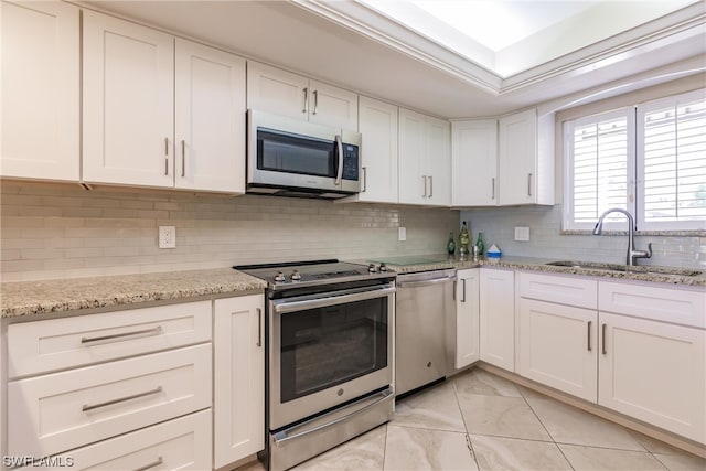 kitchen with white cabinetry, tasteful backsplash, appliances with stainless steel finishes, and sink