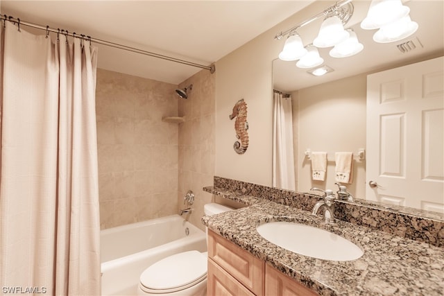 full bathroom featuring toilet, shower / tub combo, and vanity with extensive cabinet space