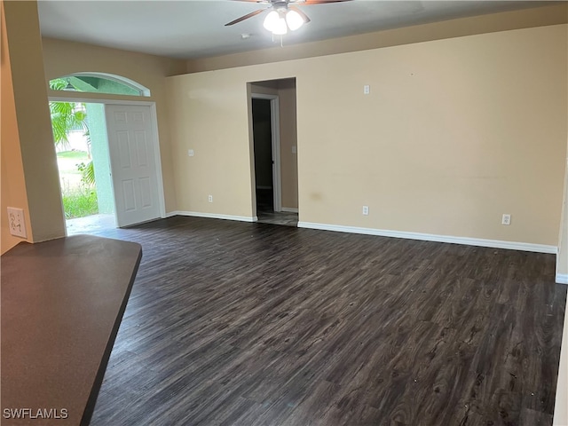 unfurnished room with dark hardwood / wood-style floors and ceiling fan