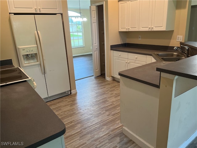 kitchen featuring white cabinets, sink, and light hardwood / wood-style flooring