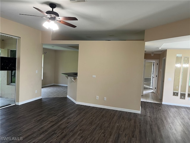 unfurnished room with ceiling fan and dark hardwood / wood-style floors