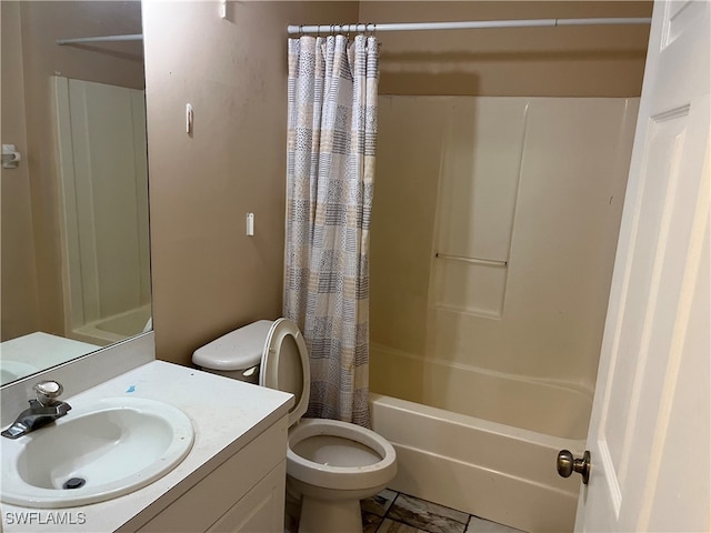 full bathroom with tile patterned floors, shower / bath combo with shower curtain, vanity, and toilet