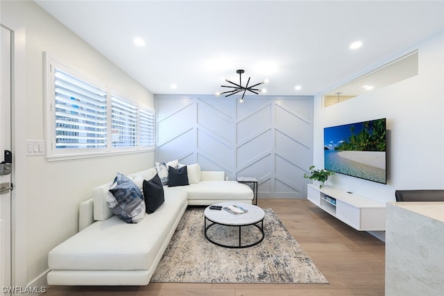 living room with a notable chandelier and hardwood / wood-style flooring