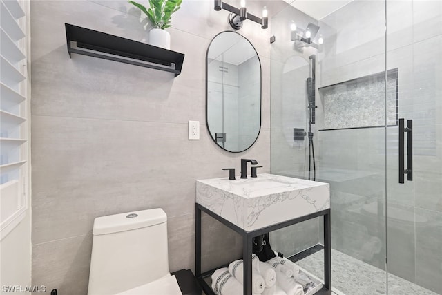 bathroom with a shower with door, oversized vanity, and toilet