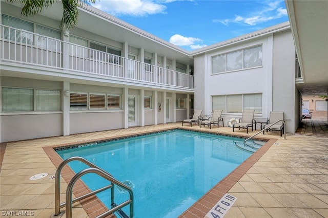 view of swimming pool with a patio area