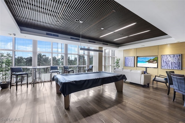 game room featuring expansive windows, wood-type flooring, billiards, and a tray ceiling