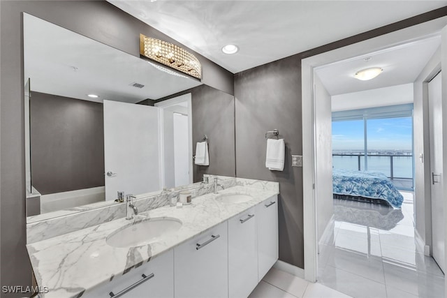 bathroom featuring tile patterned floors, vanity, and a water view