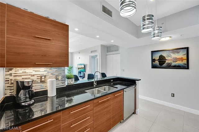 kitchen with dishwasher, sink, dark stone countertops, tasteful backsplash, and decorative light fixtures