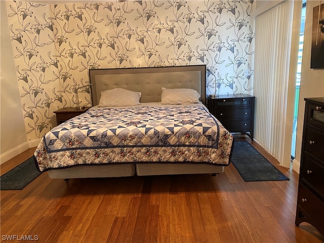 bedroom with dark wood-type flooring