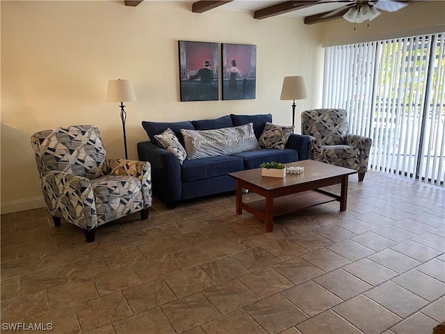 living room with dark tile flooring, beam ceiling, and ceiling fan