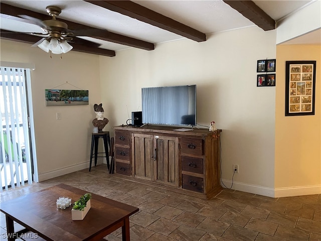 living room featuring dark tile floors, beam ceiling, and ceiling fan