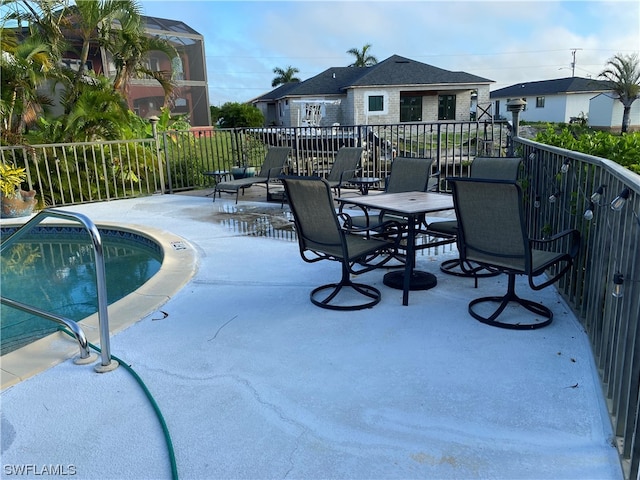 view of terrace featuring a fenced in pool