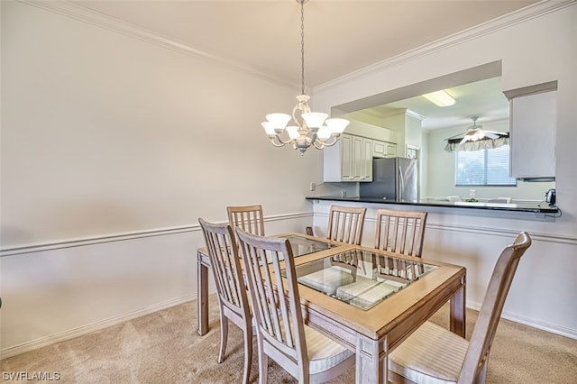 carpeted dining room with ornamental molding and ceiling fan with notable chandelier