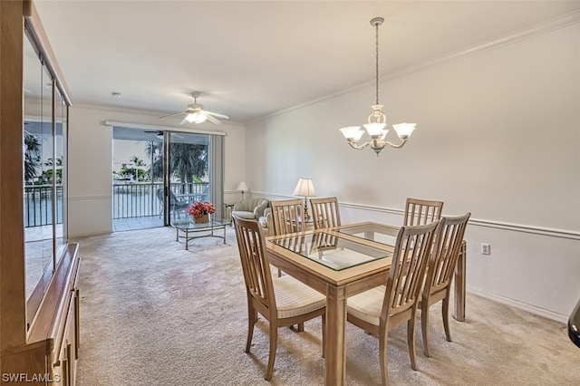 dining area featuring ornamental molding, ceiling fan with notable chandelier, and light colored carpet