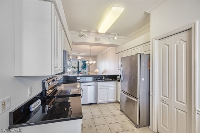 kitchen with white cabinetry, decorative light fixtures, a notable chandelier, stainless steel appliances, and light tile floors