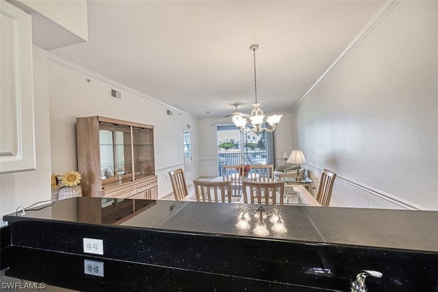 dining room with a chandelier and ornamental molding