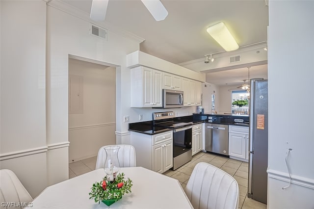 kitchen featuring light tile flooring, ceiling fan, appliances with stainless steel finishes, and white cabinetry