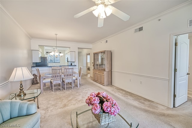 carpeted living room with crown molding and ceiling fan with notable chandelier