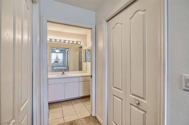 bathroom with tile floors, vanity, and ceiling fan