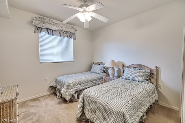 bedroom with ceiling fan and light colored carpet