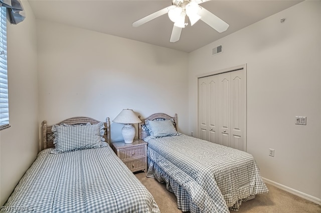 carpeted bedroom with a closet and ceiling fan