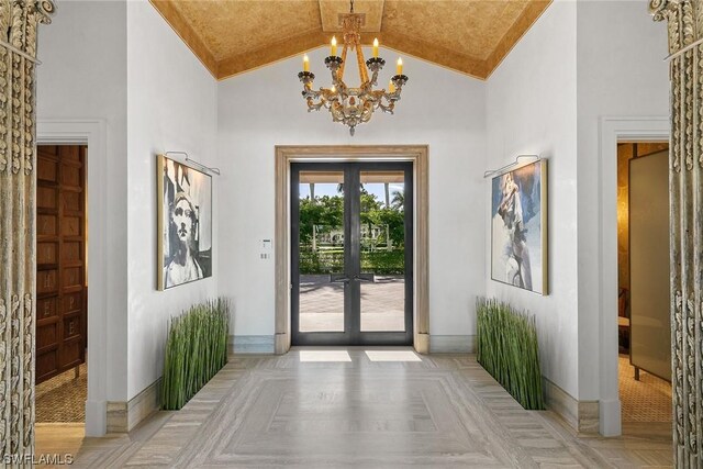 doorway featuring light parquet floors, a chandelier, high vaulted ceiling, and french doors