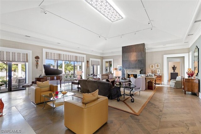 living room featuring crown molding, a fireplace, high vaulted ceiling, and a raised ceiling