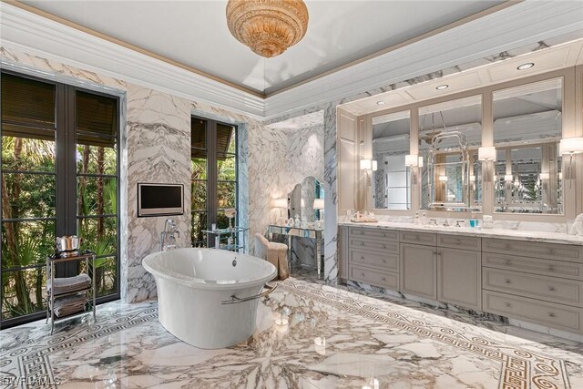 bathroom with ornamental molding, a bathtub, and vanity