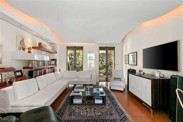 tiled living room with lofted ceiling