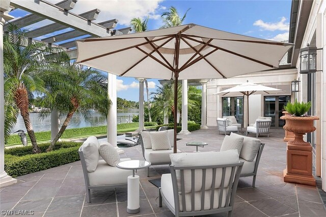 view of patio / terrace featuring a pergola, an outdoor hangout area, and a water view