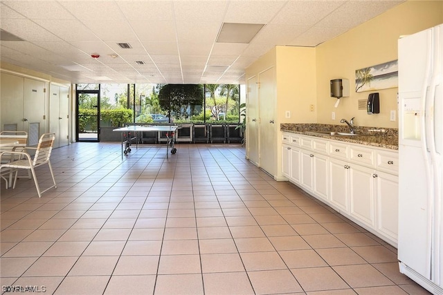 8350 Estero Blvd Unit 423, Fort Myers Beach, FL 33931 - kitchen featuring visible vents, a sink, open floor plan, white fridge with ice dispenser, and light tile patterned floors
