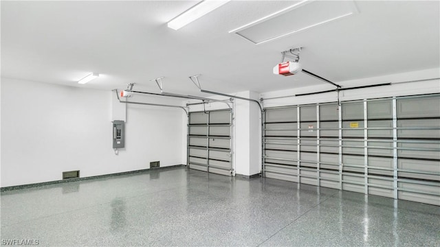 garage featuring a garage door opener and electric panel