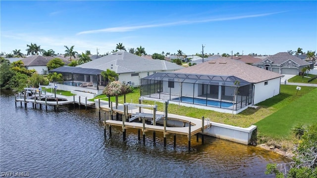 view of dock featuring a lawn, a water view, and glass enclosure