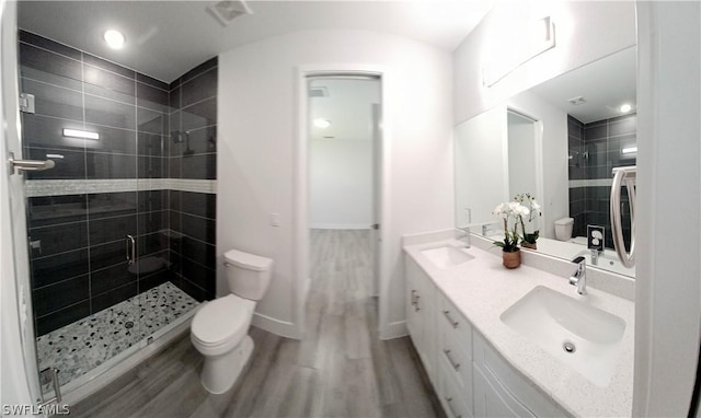 bathroom with wood-type flooring, toilet, an enclosed shower, and vanity