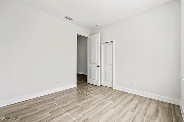 spare room featuring light hardwood / wood-style floors