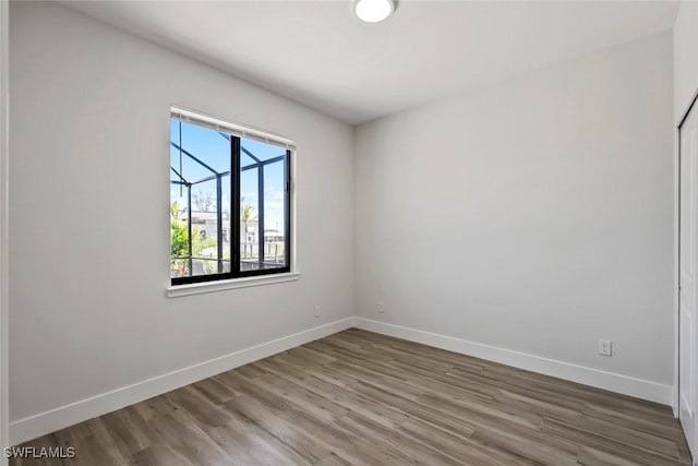 spare room with hardwood / wood-style flooring