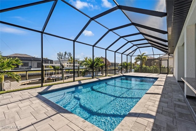 view of swimming pool featuring a lanai, a dock, and a patio area